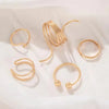 Set of gold hoop earrings on a light background