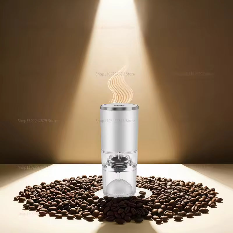 Clear coffee grinder surrounded by coffee beans on a wooden surface with a warm light background