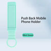 Mint green push back mobile phone holder on a light blue background
