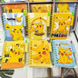 Collection of notebooks with Pikachu designs on a shelf.