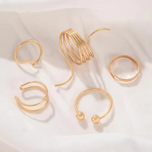Set of gold hoop earrings on a light background