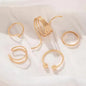 Set of gold hoop earrings on a light background