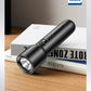 Black flashlight on a stack of books with Philips logo in the background